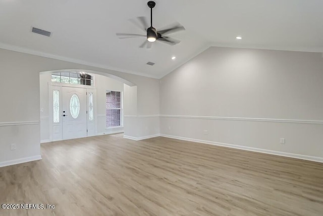 foyer featuring visible vents, baseboards, a ceiling fan, light wood-style floors, and vaulted ceiling