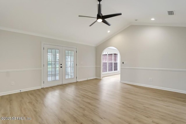 empty room featuring vaulted ceiling, french doors, wood finished floors, baseboards, and ceiling fan