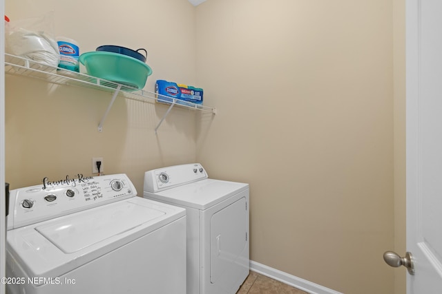 laundry room featuring light tile patterned flooring, baseboards, independent washer and dryer, and laundry area