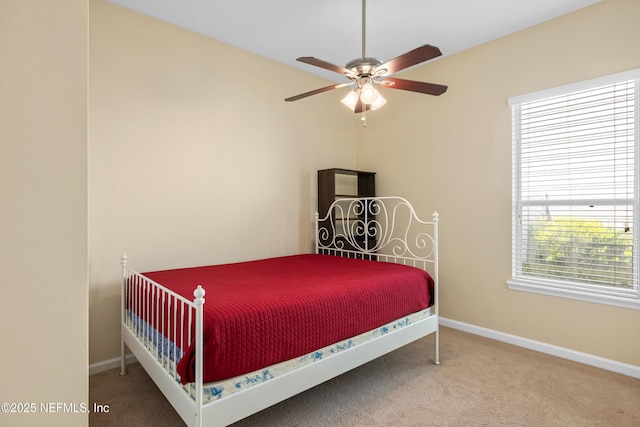 carpeted bedroom with baseboards and ceiling fan