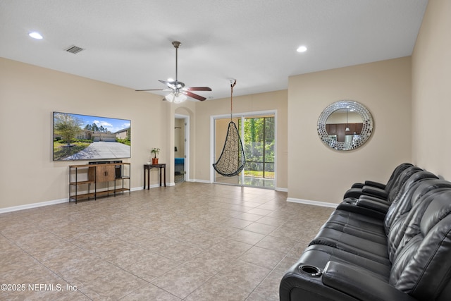 living room featuring light tile patterned floors, baseboards, visible vents, arched walkways, and ceiling fan