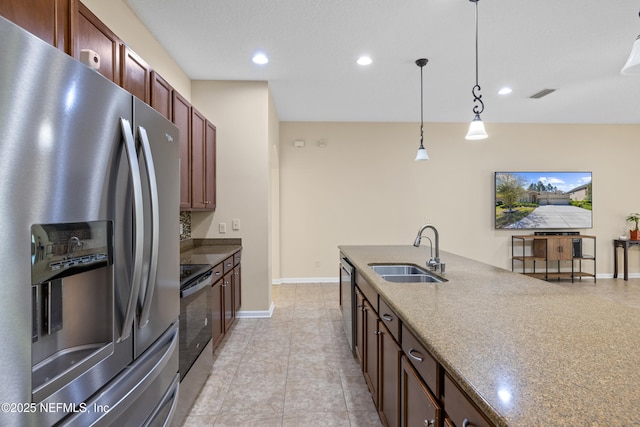 kitchen with a sink, appliances with stainless steel finishes, hanging light fixtures, baseboards, and visible vents