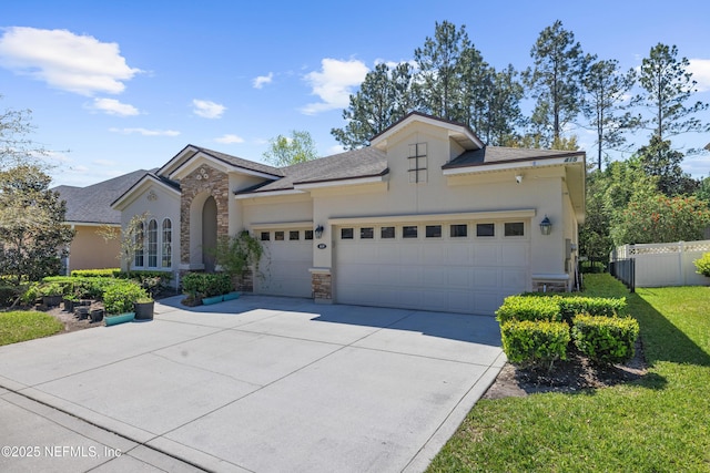 view of front of property with stone siding, stucco siding, driveway, and a garage