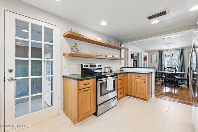 kitchen with open shelves, dark countertops, visible vents, stainless steel electric stove, and decorative backsplash