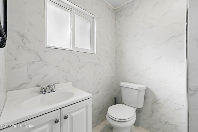 bathroom featuring marble finish floor, toilet, and vanity