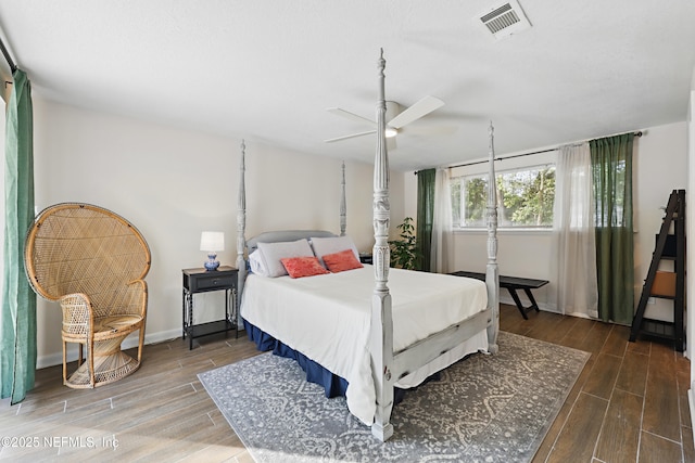 bedroom with a ceiling fan, wood finish floors, baseboards, and visible vents