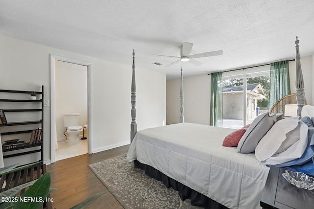 bedroom with access to exterior, wood finished floors, a textured ceiling, ensuite bath, and visible vents