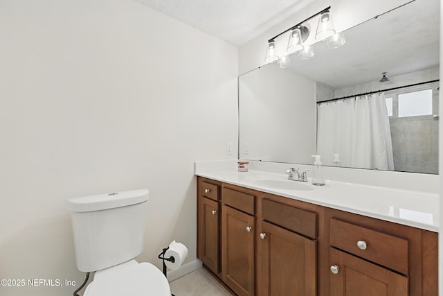 bathroom featuring toilet, tile patterned floors, and vanity