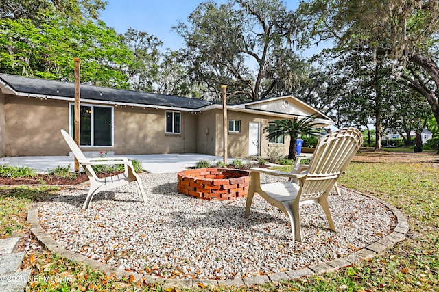 back of house featuring stucco siding and a patio
