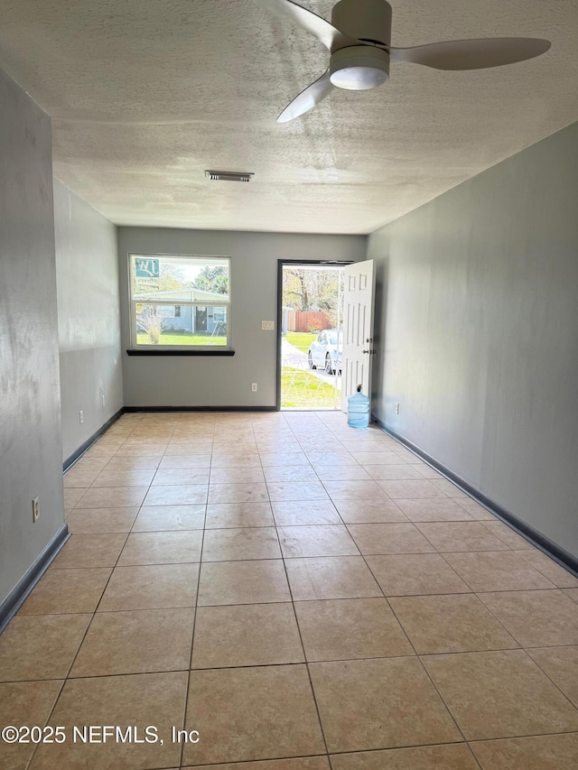 5521 Sabena Rd, Jacksonville, FL 32207 - tiled spare room with a textured ceiling, a ceiling fan, and baseboards