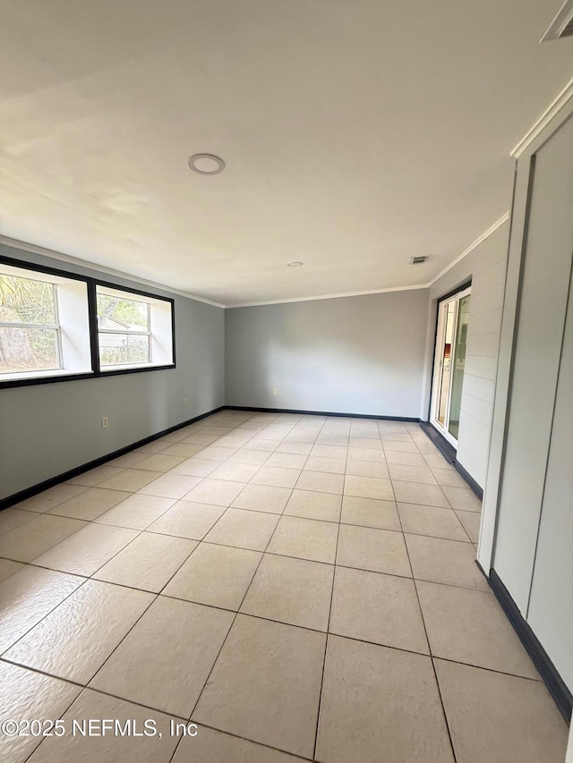 5521 Sabena Rd, Jacksonville, FL 32207 - spare room featuring light tile patterned floors, crown molding, visible vents, and baseboards