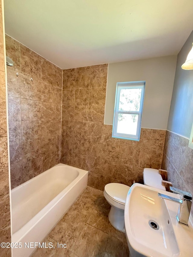 5521 Sabena Rd, Jacksonville, FL 32207 - full bath featuring tile walls, a sink, shower / bathtub combination, toilet, and a wainscoted wall