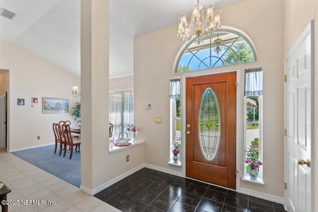 388 Lolly Ln, Saint Johns, FL 32259 - entryway featuring vaulted ceiling, an inviting chandelier, baseboards, and visible vents