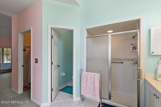 388 Lolly Ln, Saint Johns, FL 32259 - bathroom with baseboards, a stall shower, toilet, and a spacious closet
