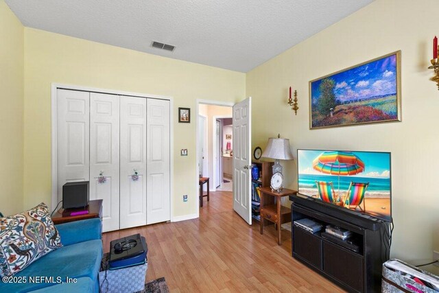 388 Lolly Ln, Saint Johns, FL 32259 - living room featuring light wood-type flooring, a textured ceiling, and visible vents