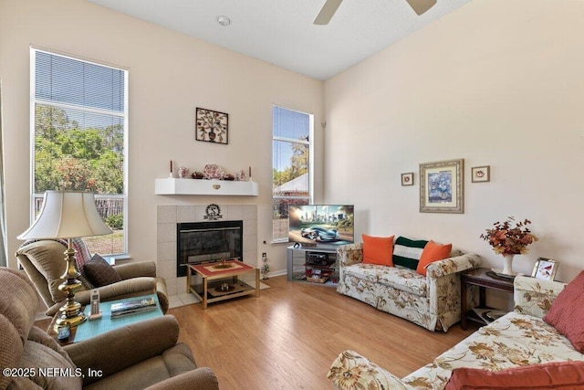 388 Lolly Ln, Saint Johns, FL 32259 - living area with a ceiling fan, plenty of natural light, a tiled fireplace, and wood finished floors