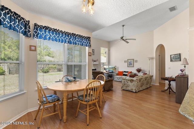 388 Lolly Ln, Saint Johns, FL 32259 - dining space with light wood-style floors, arched walkways, a textured ceiling, and visible vents