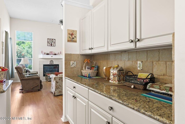388 Lolly Ln, Saint Johns, FL 32259 - kitchen with white cabinets, light stone countertops, and light wood-type flooring