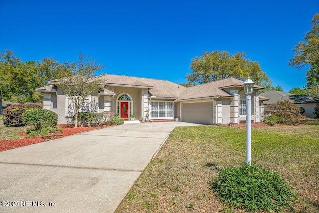 388 Lolly Ln, Saint Johns, FL 32259 - view of front of property with an attached garage, driveway, stucco siding, and a front yard