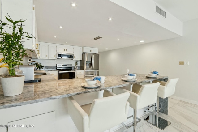 2280 Shepard St Unit 603, Jacksonville, FL 32211 - kitchen with a sink, a peninsula, stainless steel appliances, and visible vents