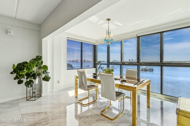 2280 Shepard St Unit 603, Jacksonville, FL 32211 - dining area featuring a water view, a wealth of natural light, marble finish floor, and a notable chandelier