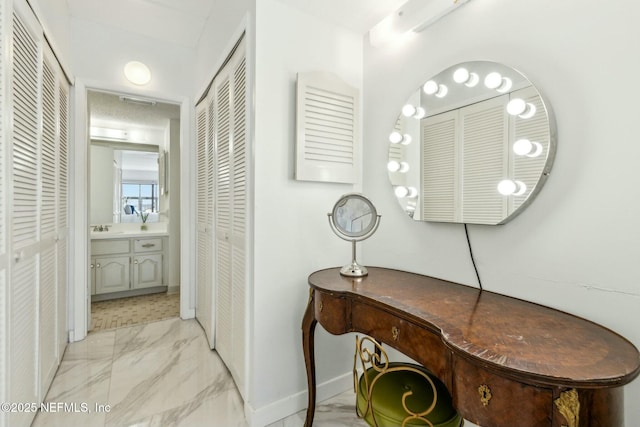 2280 Shepard St Unit 603, Jacksonville, FL 32211 - bathroom featuring marble finish floor, vanity, baseboards, and a closet