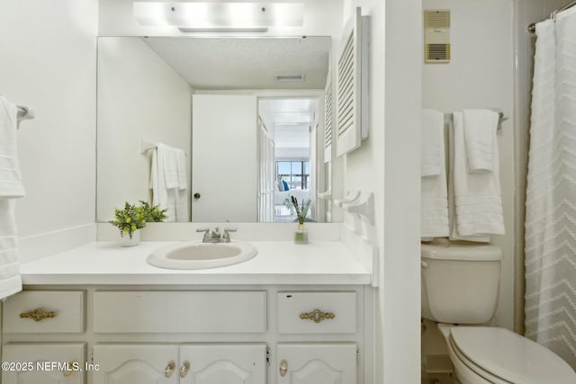 2280 Shepard St Unit 603, Jacksonville, FL 32211 - bathroom with toilet, vanity, and a textured ceiling