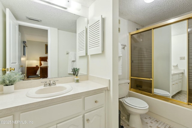 2280 Shepard St Unit 603, Jacksonville, FL 32211 - full bathroom featuring vanity, toilet, bath / shower combo with glass door, a textured ceiling, and visible vents