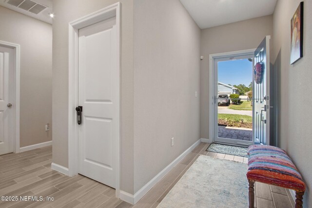 281 Tintamarre Dr, Saint Augustine, FL 32092 - entrance foyer featuring baseboards, wood tiled floor, and visible vents