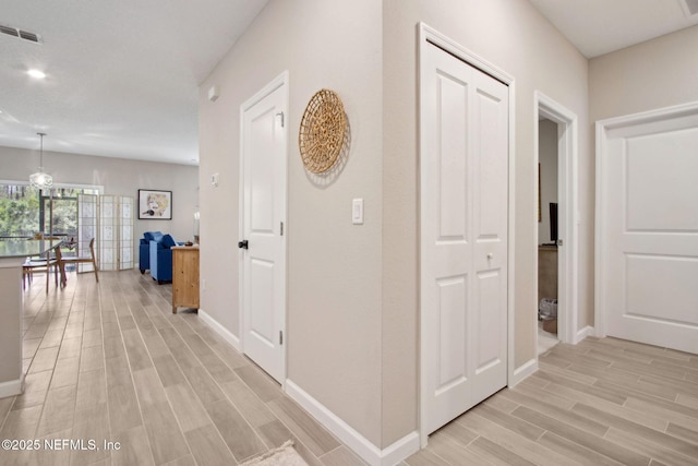 281 Tintamarre Dr, Saint Augustine, FL 32092 - hallway with baseboards, wood tiled floor, and visible vents