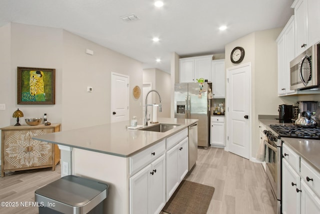 281 Tintamarre Dr, Saint Augustine, FL 32092 - kitchen featuring white cabinetry, light wood-type flooring, a sink, visible vents, and appliances with stainless steel finishes