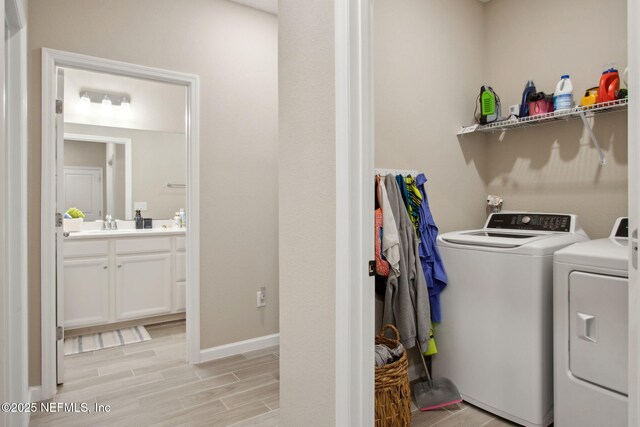 281 Tintamarre Dr, Saint Augustine, FL 32092 - laundry area featuring wood finish floors, baseboards, separate washer and dryer, a sink, and laundry area