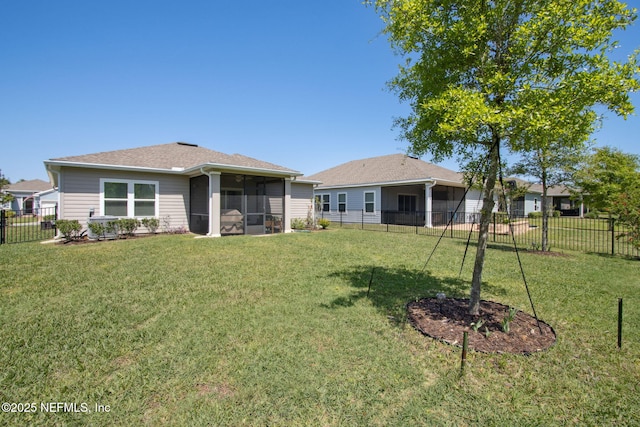 281 Tintamarre Dr, Saint Augustine, FL 32092 - rear view of property with a lawn, a sunroom, a fenced backyard, and roof with shingles