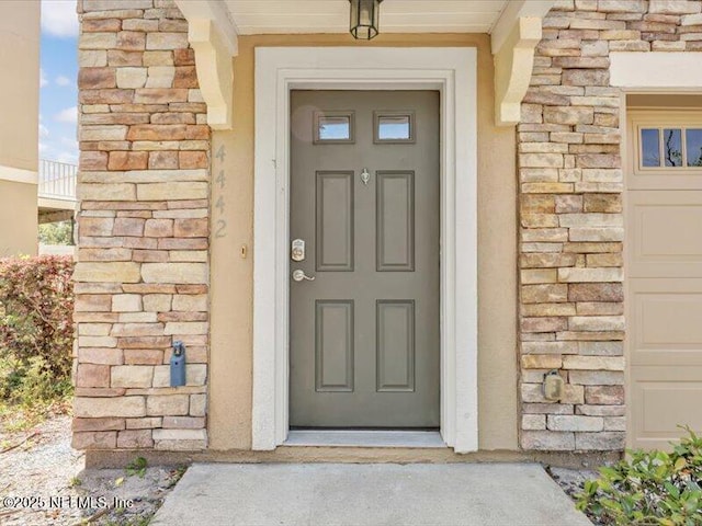 4442 Capital Dome Dr, Jacksonville, FL 32246 - property entrance with stucco siding and stone siding