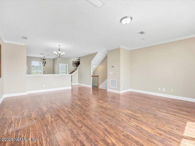 4442 Capital Dome Dr, Jacksonville, FL 32246 - unfurnished living room with wood finished floors, a notable chandelier, baseboards, and visible vents