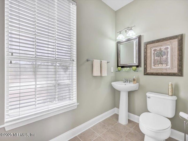 4442 Capital Dome Dr, Jacksonville, FL 32246 - bathroom featuring baseboards, toilet, and tile patterned floors