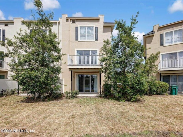 4442 Capital Dome Dr, Jacksonville, FL 32246 - back of property featuring stucco siding and a yard