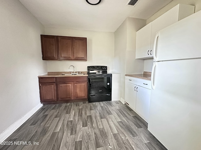 11920 Betula Rd, Jacksonville, FL 32246 - kitchen featuring wood finished floors, a sink, electric range, baseboards, and freestanding refrigerator