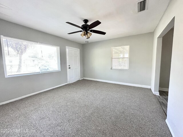 11920 Betula Rd, Jacksonville, FL 32246 - unfurnished room featuring a ceiling fan, carpet flooring, visible vents, and plenty of natural light