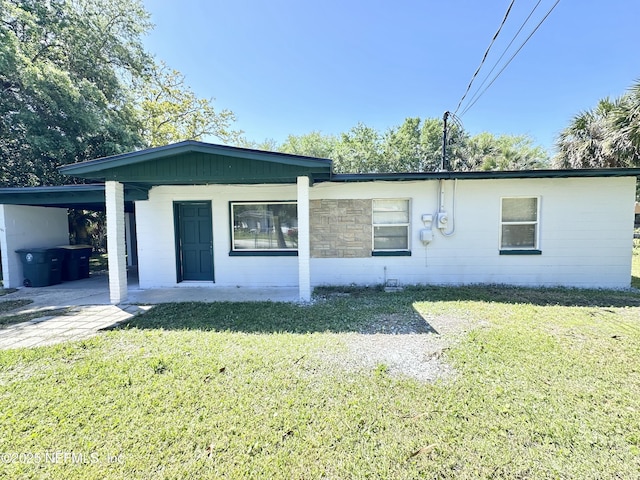 11920 Betula Rd, Jacksonville, FL 32246 - single story home featuring concrete block siding, a front yard, and a carport