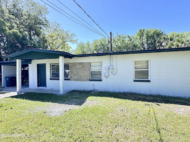 11920 Betula Rd, Jacksonville, FL 32246 - view of home's exterior with a lawn and an attached carport