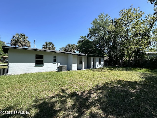 11920 Betula Rd, Jacksonville, FL 32246 - rear view of house featuring central AC, fence, concrete block siding, and a yard
