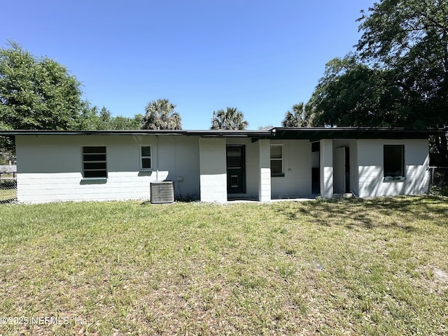 11920 Betula Rd, Jacksonville, FL 32246 - rear view of property featuring a lawn, concrete block siding, and central air condition unit