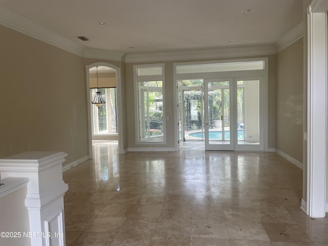unfurnished room with baseboards, visible vents, crown molding, and french doors