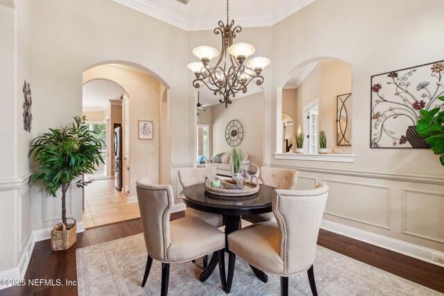 553 S Bridge Creek Dr, Saint Johns, FL 32259 - dining room with wood finished floors, arched walkways, a decorative wall, and a chandelier