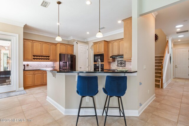 553 S Bridge Creek Dr, Saint Johns, FL 32259 - kitchen featuring stainless steel fridge, ornamental molding, a breakfast bar, a peninsula, and black microwave