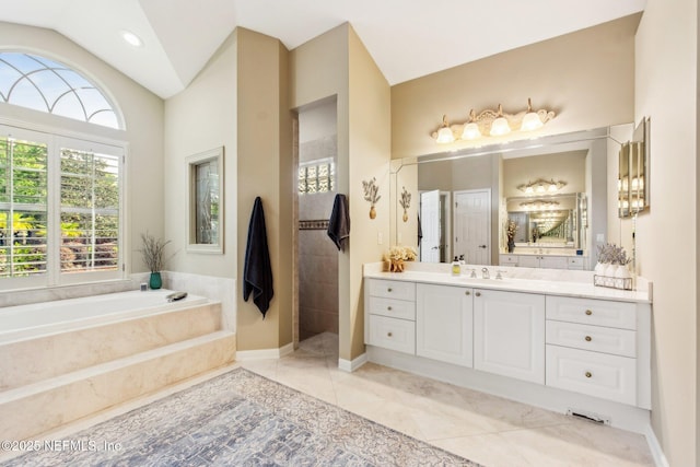 553 S Bridge Creek Dr, Saint Johns, FL 32259 - bathroom featuring tile patterned floors, vanity, lofted ceiling, a garden tub, and a walk in shower