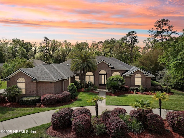 553 S Bridge Creek Dr, Saint Johns, FL 32259 - view of front facade featuring a lawn and brick siding