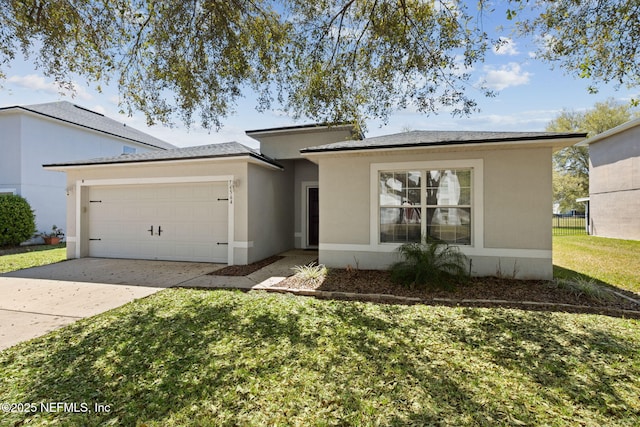 view of front facade featuring a front yard, concrete driveway, stucco siding, fence, and a garage