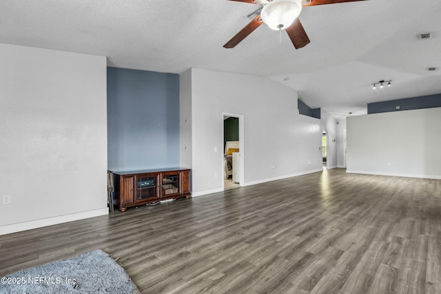 unfurnished living room with lofted ceiling, baseboards, ceiling fan, visible vents, and wood finished floors